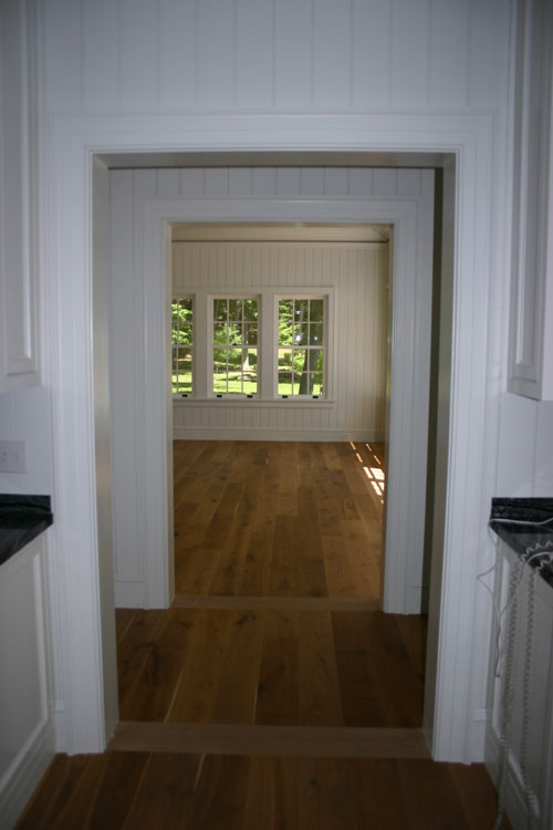 Beadboard and molding on walls leading into the breakfast room